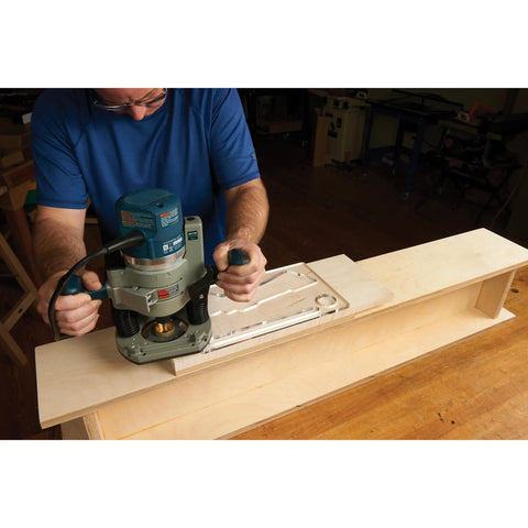 Woodworker using Top Shelf Cleaver Style Cutting Board Router Template with router on hardwood.
