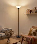 Sky Dome Dimmable LED Floor Lamp For Living Room, Bedroom Or Office In Jet Black Finish, Tall Torch Style by a cozy sofa