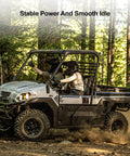 Off-road vehicle driving on a dirt trail in the forest, showcasing Heavy Duty Ignition Module CDI Box Replacement For John Deere Gator HPX 4X2 4X4 And Kawasaki Mule 1000 2500 2510 2520 3000 3010 With Stable Spark Reliable Ignition Timing And Easy Start In Harsh Conditions Replace 21119-2160 ability to provide stable power and smooth idle.