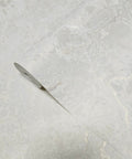 Ivory And Off White Rose Gold Cracked Faux Concrete Plaster Textured Wallpaper Rolls on a smooth surface showcasing matte finish.