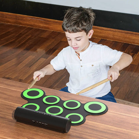 Child playing Portable Electronic Drum Set For Practice And Performance with snare toms crash ride hi hat pads and dual foot pedals.