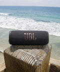 Flip 6 Portable Bluetooth Speaker With Loud Power And Deep Bass, IPX7 Waterproof, 12 Hour Playtime, PartyBoost, on beach