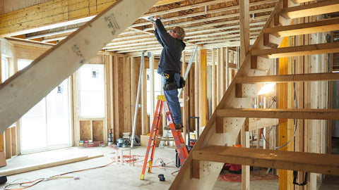 Person using Green Beam Self Leveling Alignment Laser With Plumb And Level Points on construction site