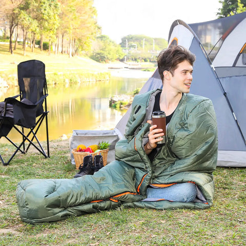 Person sitting in Cold Weather Mummy Sleeping Bag For Hiking And Camping With No Snag Zipper 20 Degree Temperature Rating
