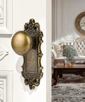 Bronze Interior Dummy Door Knobs, 2 Pack - Antique Bronze Door Handles on white door with Baroque-inspired design, living room.