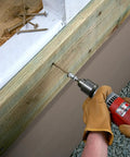 Using a drill with Exterior Grade Timber Screws 0.220 Inch By 4 Inch Double Barrier Coated on outdoor wood project.