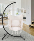 Indoor Hammock Chair With Rope Swing, Macrame Boho Hanging Chair With 2 Cushions in a modern living room, supports up to 330 lbs