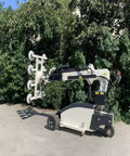 Heavy Duty Electric Glass Vacuum Lifter With Wireless Remote And Suction Cup Hoist For Pro Installers That Pulls Serious Weight and moves glass panels in outdoor setting.