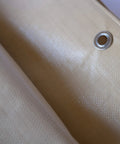 Close-up of Heavy Duty Waterproof Tarp 20 Ft By 30 Ft 12 Mil Thick Tan Tarp with reinforced corner and rope hem.
