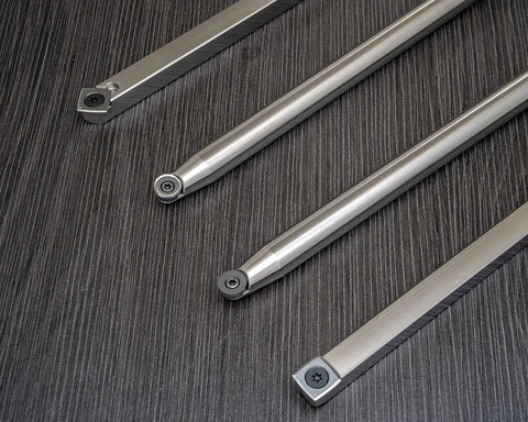 Four carbide woodturning tools with 12-inch bars and 17-inch stainless steel handles, top-down view