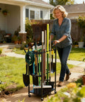Woman using Heavy Duty Rolling Garden Tool Organizer On Wheels With 14 Hooks And 5 Slots, 3 Tier Metal Cart on lawn.