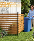 Woman placing trash can behind Two Panels Wood Privacy Screen For Garden And Patio 41 By 38 Inches No Dig Outdoor Privacy Wall