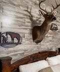 Vibe Ready Vinyl Wall Panels With Vintage Farmhouse Wood Pattern in bedroom, featuring deer mount and rustic decor.