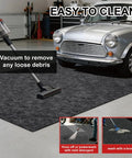 Heavy Duty Garage Floor Mat For Under Car 17 Foot By 7.45 Foot Waterproof Absorbent Oil Spill Protector being vacuumed in garage