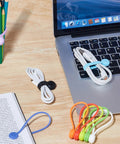 Magnetic Cable Ties 10 Pack Reusable Cable Organizers for earbuds and cords shown securing cables on desk near laptop.