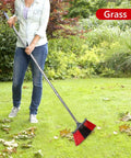 Person using Heavy Duty Long Handle Outdoor Broom 62 Inch For Tough Yard Work And Garage Cleanup Hard Bristle Sweep Brush in grass.