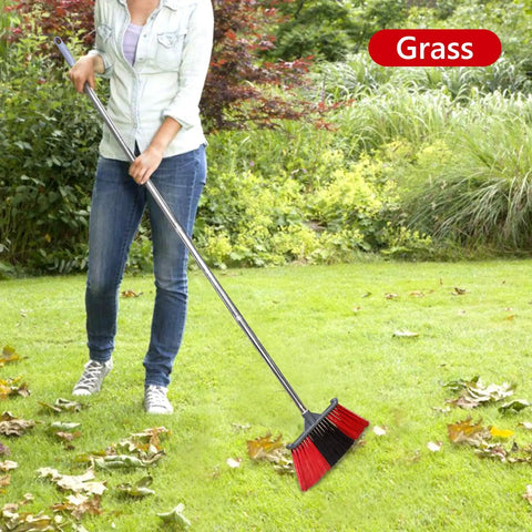 Person using Heavy Duty Long Handle Outdoor Broom 62 Inch For Tough Yard Work And Garage Cleanup Hard Bristle Sweep Brush in grass.