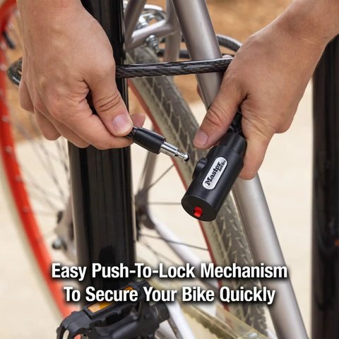 Person using 5 Ft Black Cable Bike Lock With Key Heavy Duty Braided Steel Self Coiling Vinyl Coated to secure bicycle