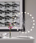 Coney Large LED Ferris Wheel Desk Lamp With Chrome Finish on modern office table with floral and car art background