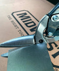 Close-up of Long Cut Tin Snips With Offset Design For Straight And Curved Cuts In Sheet Metal Projects, cutting through metal.