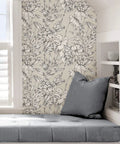 Grey Cayman Peel And Stick Wallpaper With Tropical Botanical Design Neutral Removable Self Adhesive Wall Covering For Renters Easy Install And Repositioning No Residue Dope Look For Accent Walls covering wall beside grey seat area, showcasing hibiscus and palm fronds.