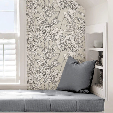 Grey Cayman Peel And Stick Wallpaper With Tropical Botanical Design Neutral Removable Self Adhesive Wall Covering For Renters Easy Install And Repositioning No Residue Dope Look For Accent Walls covering wall beside grey seat area, showcasing hibiscus and palm fronds.