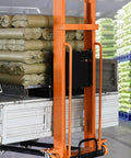 Heavy Duty Electric Pallet Stacker With Rock Solid Hydraulic Rig Designed To Haul 1100 Lb Pallets And Climb Four Feet High Without Breaking A Sweat In Crowded Shops lifting bags on a truck.