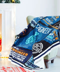 Colorful flannel blanket with engineer-themed designs draped over a chair, part of Engineer Appreciation Gift Set With Blanket, Multi Tool Pen, Keychain And Socks For Men, The Go To Gift For Husbands, Dads, And Grandpas On Birthday, Retirement, Or Fathers Day That Stands Out.