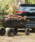 Heavy Duty 1200 Lb Poly Garden Dump Cart With 7 Cu Ft Bed, Quick Release 2-In-1 Convertible Handle And 13 Inch Pneumatic Tires loaded with logs