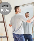 Man using Pro Grade All In One Picture Hanging Kit With Stainless Steel Wire D Rings Hooks Screws And Level for mounting mirror up to 100 lbs
