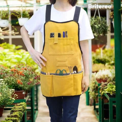 Person wearing Durable Canvas Work Apron With 21 Tool Pockets, Handy Magnetic Holder, ideal for gardening in greenhouse.