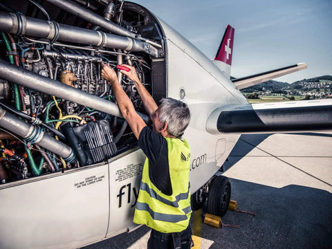 Technician repairing aircraft engine with Gasoline Slotted And Phillips Screwdriver Kit With Alloy Steel Bits Pro Grade Set for repairs.