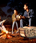Group enjoying outdoor campfire with Beefy Firewood Rack For Outdoor Use, 29 Inch Log Holder, Black Steel Frame visible nearby.