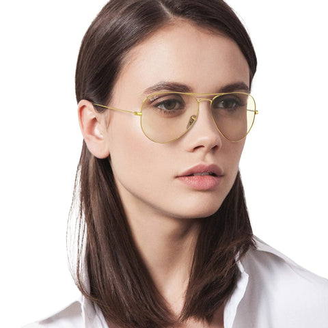 Person wearing Classic Polarized Aviator Sunglasses With Gold Frames And Photochromic Grey Lenses, 58mm, Medium Fit For Men And Women.