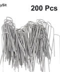Pile of heavy duty 6 inch 11 gauge galvanized garden stakes, 200 pack, used for anchoring weed barrier fabric and landscaping