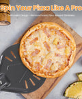 Front view of Leightszen pizza turning peel, perforated aluminum, dark gray, with pineapple pizza on wooden board.