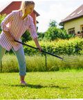 Woman using Handheld Pitch Fork For Manure And Straw Cleanup, Lightweight Farm Fork, in garden for quick cleanup