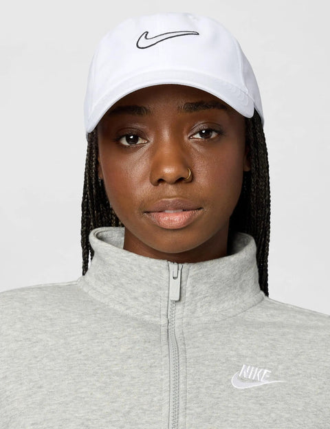 Person wearing Unstructured Swoosh Cap White On White Casual Baseball Hat Small Medium Fit Lightweight Everyday Headwear