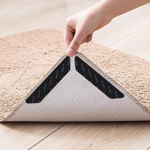No Slip Carpet Gripper Kit 16 Pack Reusable Washable Rug Pads And Edge Clips applied under a corner of a beige carpet
