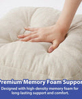 Close-up of a beige tufted indoor chair pad with memory foam support being pressed by a hand, showcasing the cushion's softness.