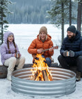 Family enjoying winter campfire in Beefy 60 Inch Galvanized Steel Fire Pit Ring Raised 12 Inch Heavy Duty Wood Burning Campfire Ring