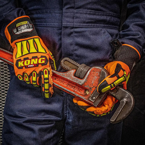 Person wearing mens cut resistant work gloves with TPR finger coverage and high grip PVC dotted palm level 5 abrasion using a pipe wrench