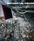 Ultra Lightweight Aluminum Folding Camping Table with Adjustable Legs by a tent in rocky terrain