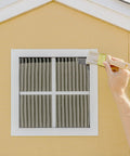 Applying Pro Grade Waterproof Patch And Seal Liquid Rubber Sealant Crystal Clear Flexible Coating to window frame with brush