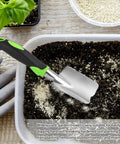 Heavy Duty Cast Aluminum Garden Hand Shovel And Trowel For Planting Transplanting Weeding And Digging Soil With Soft Rubberized Non Slip Grip Handle 11.8 Inch Green Workhorse Tool shown in use in a garden container