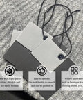 Premium Black Nylon Hang Tag Strings Featuring Slick Snap Lock Fasteners That Keep Your Apparel Pricing Secure Without Any Extra Hustle During Busy Retail Floors Or Weekend Maker Fests on a textured gray fabric.