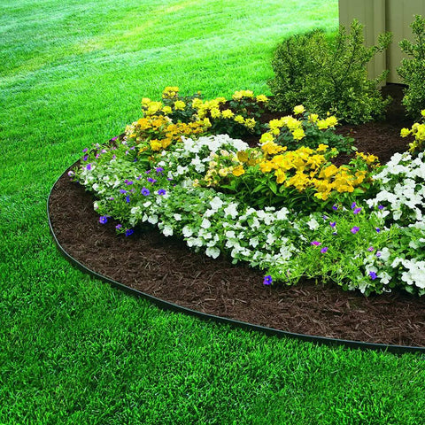 Garden flower bed curved with No Dig Landscape Edging Kit, 100 Ft Flexible Black Border, surrounded by lush green grass.