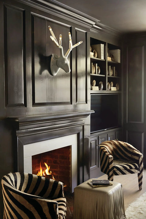 Oversized Six Light Wall Sconce In Matte Charcoal Painted Finish Killer Lodge Style Decor For Big Time Dining Room Glow and Game Changing Rustic Home Accents mounted above a fireplace in a stylish living room.