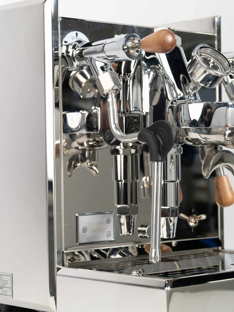 Pro Grade Dual Boiler Espresso Maker With PID Precision Tuning hardened stainless frame close-up of steam wand and portafilter.