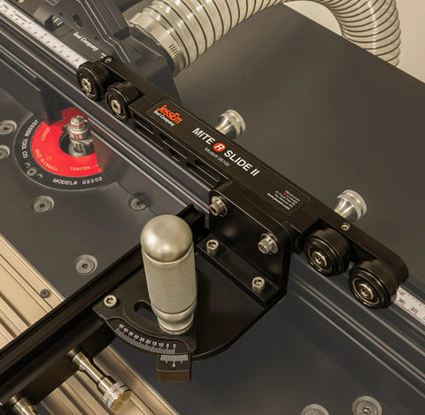 Miter Slide II Precision Miter Slot Accessory with dual aluminum tracks on router table for woodworking, featuring heavy duty locking handle.
